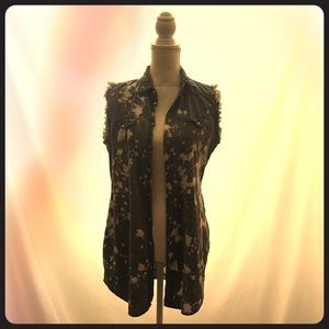Sleeveless distressed button down shirt.